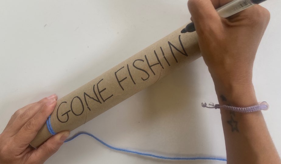 decorate the paper towel craft fishing pole with markers and crayons